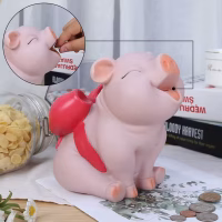 Tirelire cochon rose avec un ruban cadeau rose
